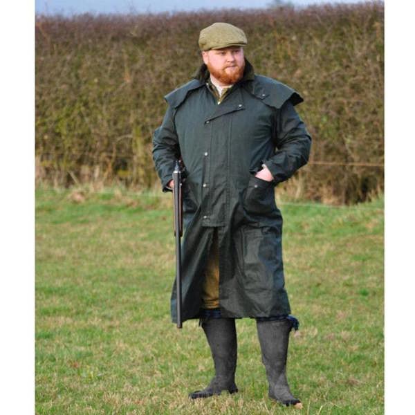 Farmer wearing Classic Wax Stockman coat with wellingtons and flat cap for working in wet conditions