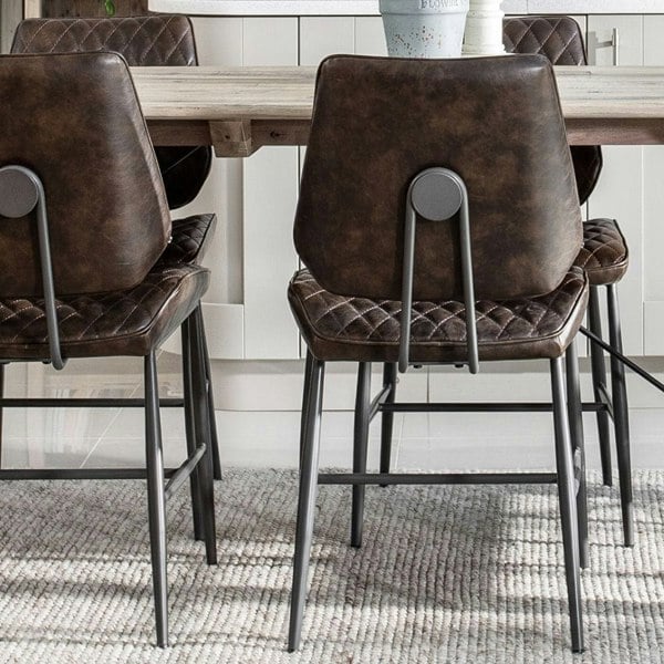 dark brown quilted dining chairs close up 