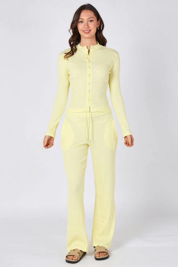 Woman wearing a light yellow outfit on a white background