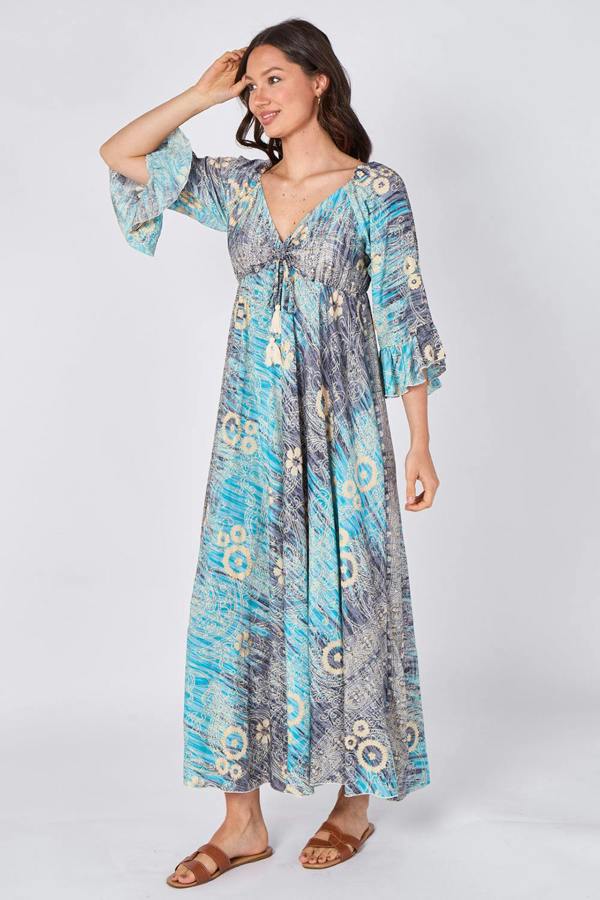 Woman wearing a patterned dress on a white background