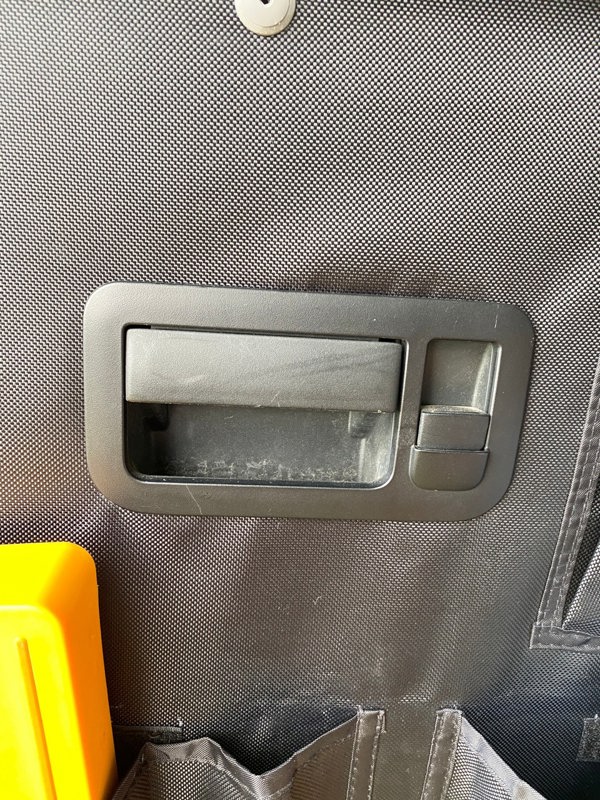 A closeup image of the VW T5/T6 Rear Barn Door Storage Organisers from OLPRO that has been cut around the door handle.