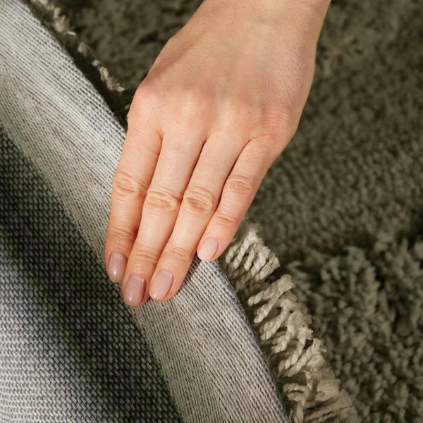 Hand on a textured surface with a focus on skin texture and color.