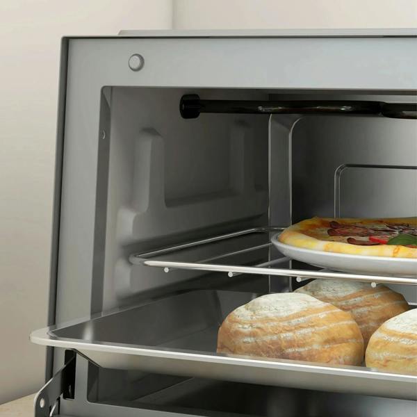 Open silver mini oven with wire rack holding pizza and bread on tray.