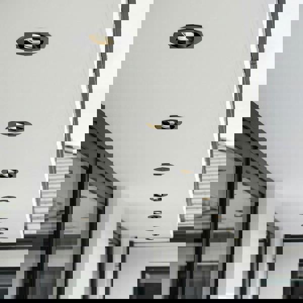 black adjustable soffit light mounted under the canopy of a modern home 