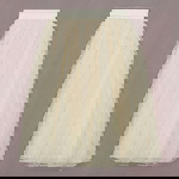 Cream tulle skirt on a plain background