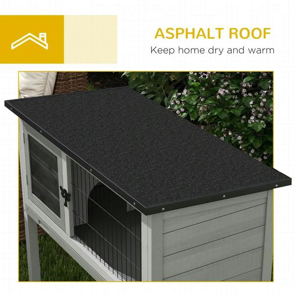Grey wooden hutch with black asphalt roof panel and wire front enclosure