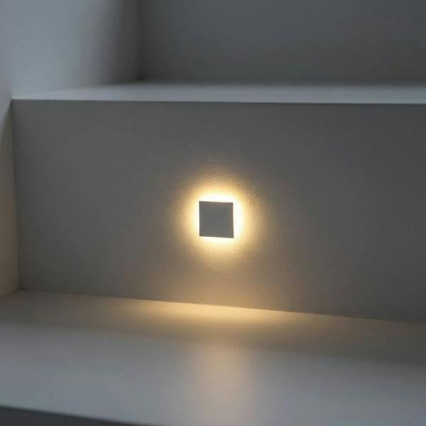 mini interior step light installed on a grey interior staircase