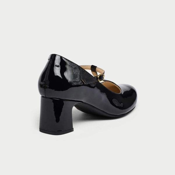 Black patent leather shoe on a white background