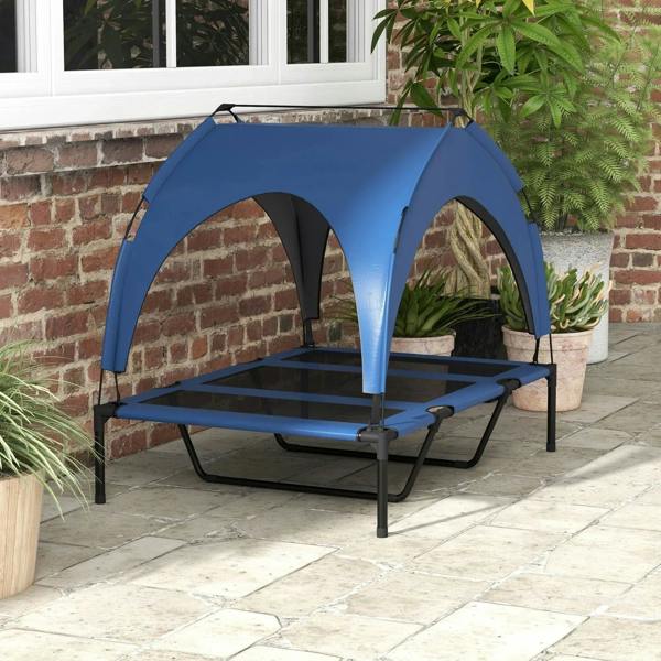 Dark blue cooling raised pet bed with canopy, outdoors on a patio