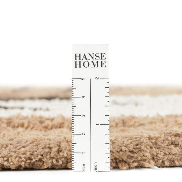 Textured fabric sample with a ruler and 'HANSE HOME' branding on a white background