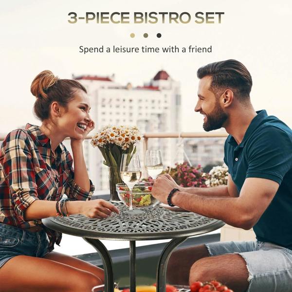 Bronze-tone round bistro table with two matching chairs outdoors