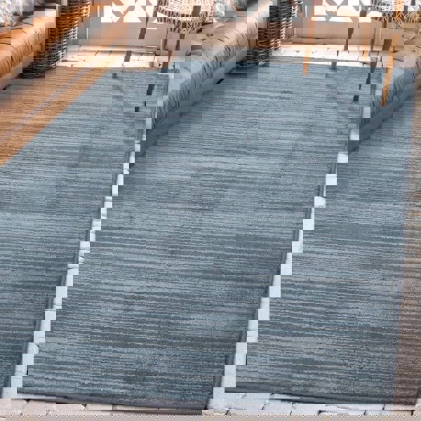 Arlo Textured Rug in soft blue tone, featuring subtle stripes, enhancing interior sophistication and comfort.