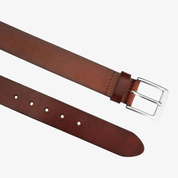 Top angle view of Brown leather belt with silver buckle on a white background