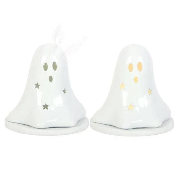 Glossy white ceramic ghost holder pair with star face cutouts and tealight bases