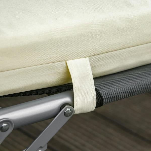 Cream white cushion tie strap fastening on rattan-style lounger frame