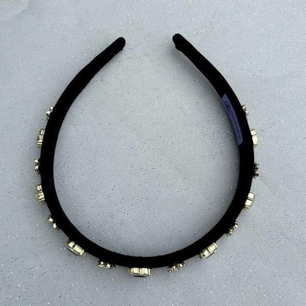 Black velvet headband, slim padded band, embellished with clear crystal gemstones, alternating square cut and floral cluster settings, gold tone accents, elegant statement hair accessory

