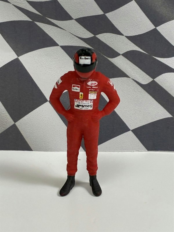 a toy figure of a race car driver