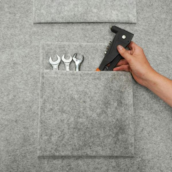Silver grey storage pouches made of felt, featuring multiple pockets holding tools like wrenches and a staple gun, ideal for organization