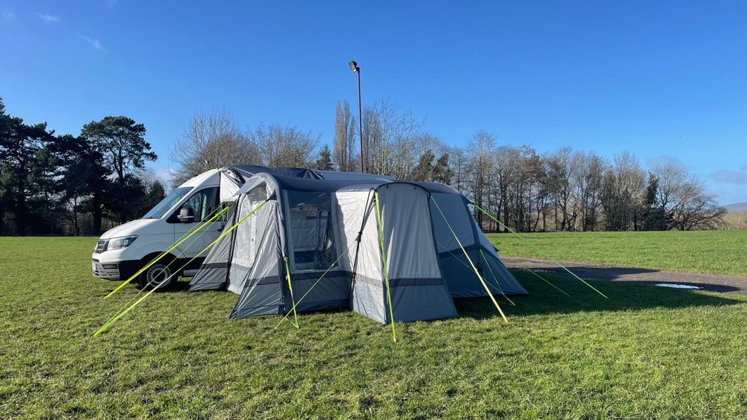 The Cocoon Breeze® XL v2 Motorhome Awning (Grey) from OLPRO pictured in a campsite attached to a VW Crafter Camper Van