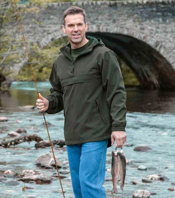 Hoggs of Fife Struther waterproof smock worn by fisherman keeping dry by the water
