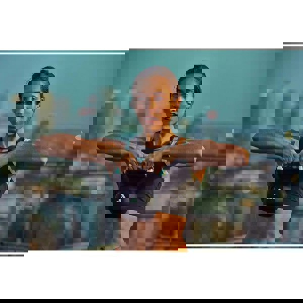 Woman exercising with a kettlebell against a city skyline