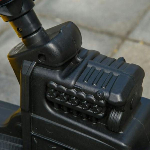 Black plastic engine-style panel detail on the ride-on construction tractor