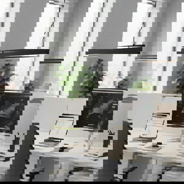 Black hanging bar light above a workstation in an office 