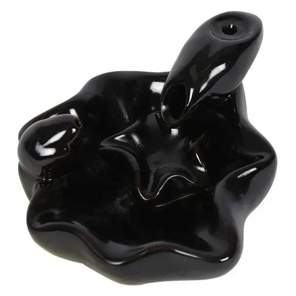 Glossy black hand incense burner with incense cone, sculpted fingers and center opening