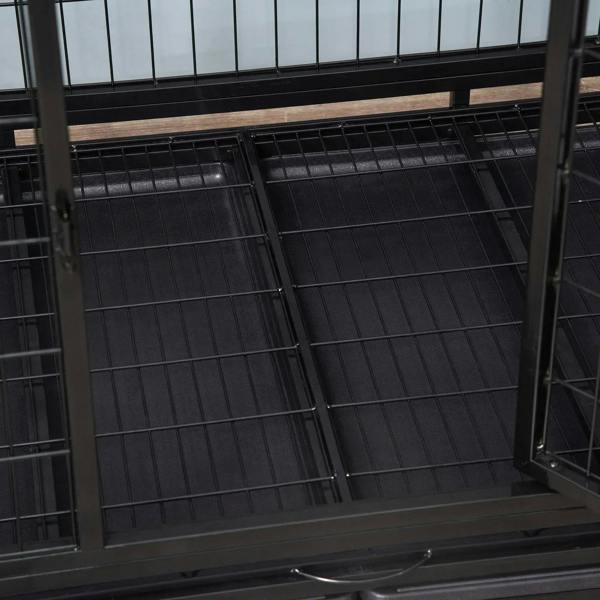 Black metal dog crate interior with grated floor panel and side door frame