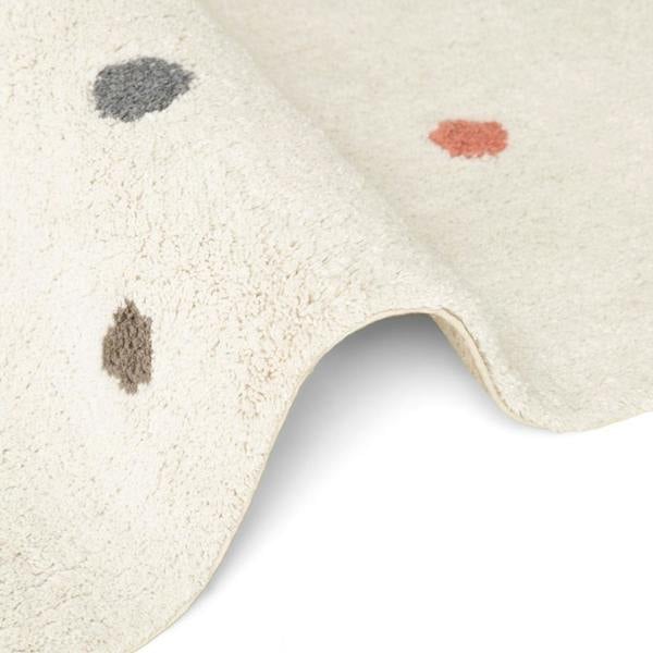 Close-up of a textured rug with abstract patterns on a white background