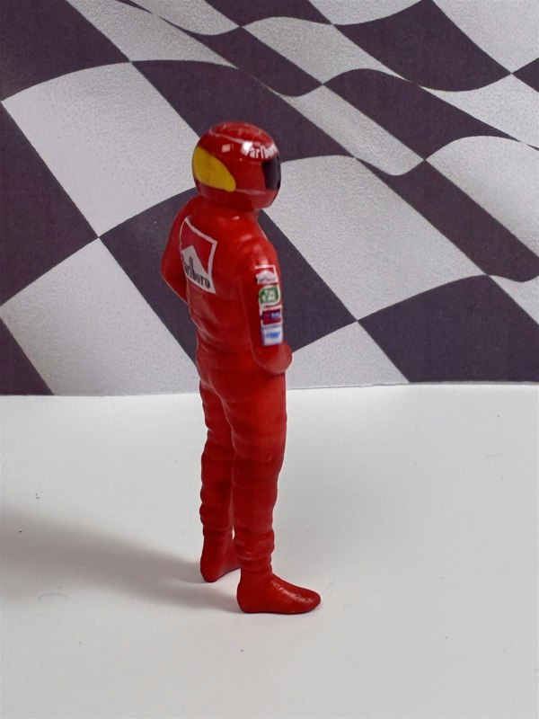 a toy figure of a race car driver
