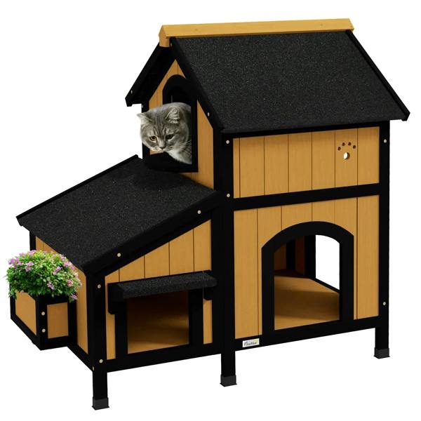Yellow wooden cat house with black shingle roof, side ramp platform and window entrance