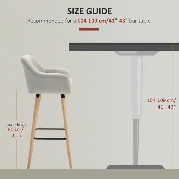 Beige upholstered bar stool with curved back and seat, light wood legs, and black footrest