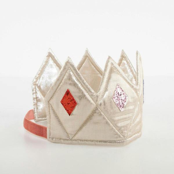 An angled studio shot of the gold lamé dress up crown showing its soft quilted interior lining and pink velvet elasticated back strap.