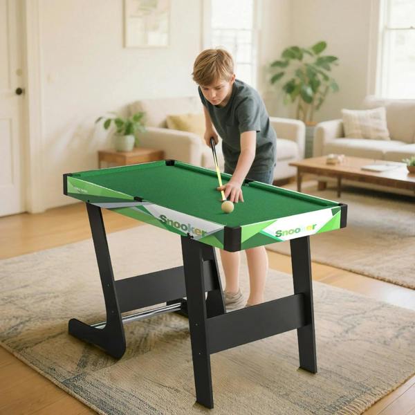 Green mini pool table set with cue over the green playing surface