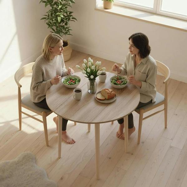 Round drop-leaf dining table with natural wood top for small dining gatherings