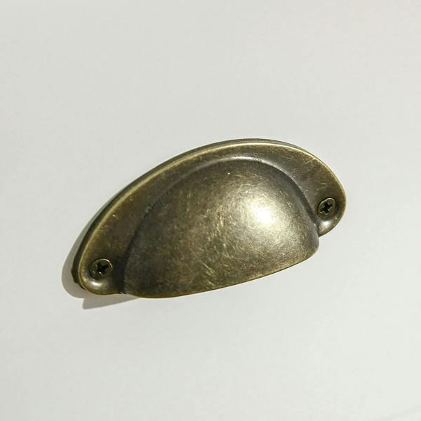 Antique gold metal cabinet handle with two mounting screws