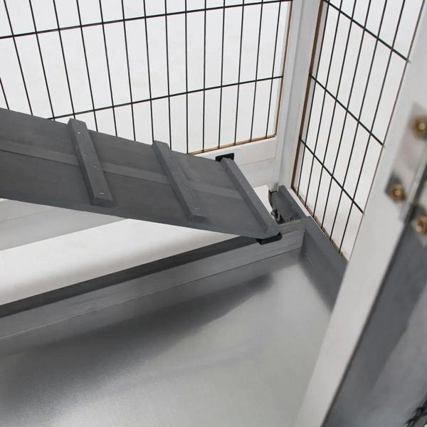 Interior ramp and wire side walls inside a grey wooden rabbit hutch