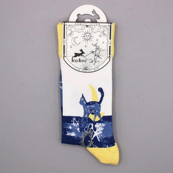 Midnight cat bamboo sock on a card; navy and yellow with cat and star print.