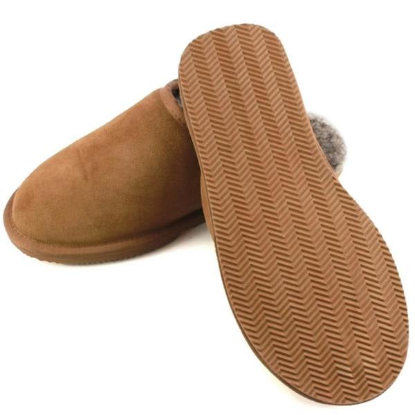 A pair of men's chestnut brown suede slipper mules on a plain white background, with one slipper flipped over to display the textured chevron grip pattern on its tan EVA sole.