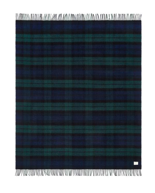 Flatlay image of a wool blanket folded into a small rectangle, the edge of the blanket is fringed, the blanket is multi-coloured check with alternating shades of dark red, faded red, navy, faded navy and cream. Image of the blanket laid out flat with fringing on both edges.