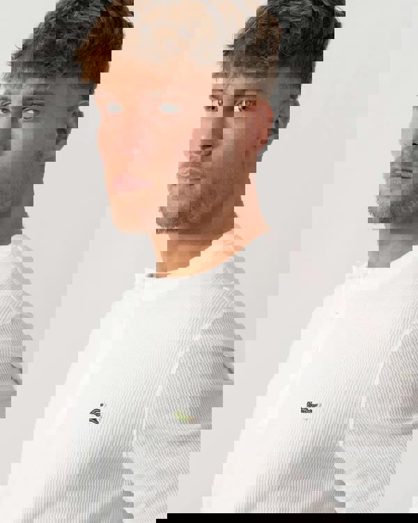 Model wearing Lacoste Boxy Tunisian Neck Knit T-Shirt in Flour 70V - Detail