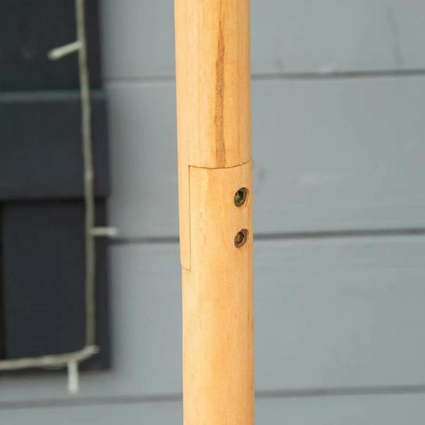 Close-up of wooden stand post with round hardware hole for bird feeder gazebo