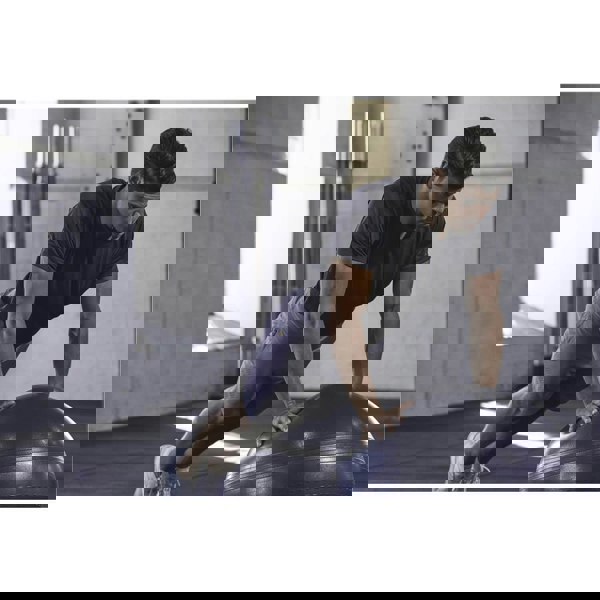 Man exercising using an Adidas 65cm Exercise Ball 