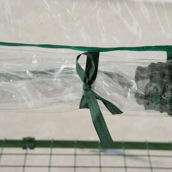 Green tie knot securing the clear PVC greenhouse cover