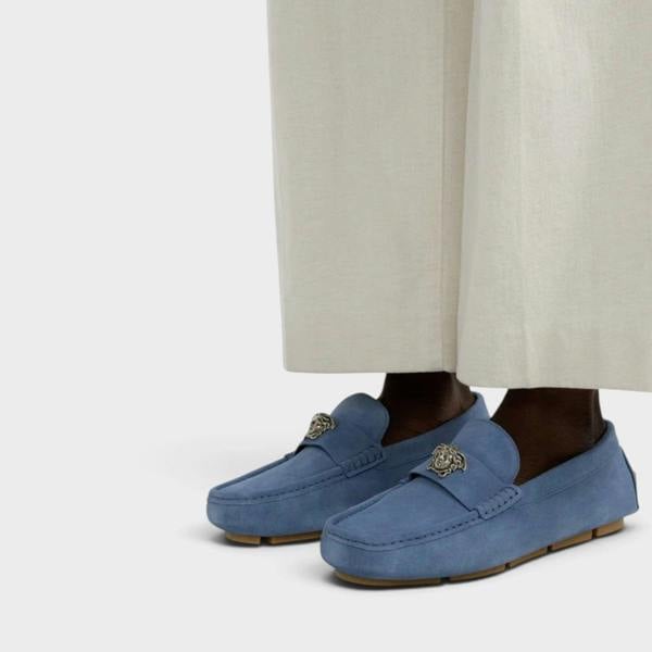 Supplied Fashion stone blue suede Versace La Medusa driver loafers with iconic silver emblem on a model
