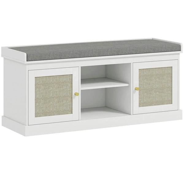 White shoe storage bench with padded top cushion, open shelves, and rattan cabinet doors