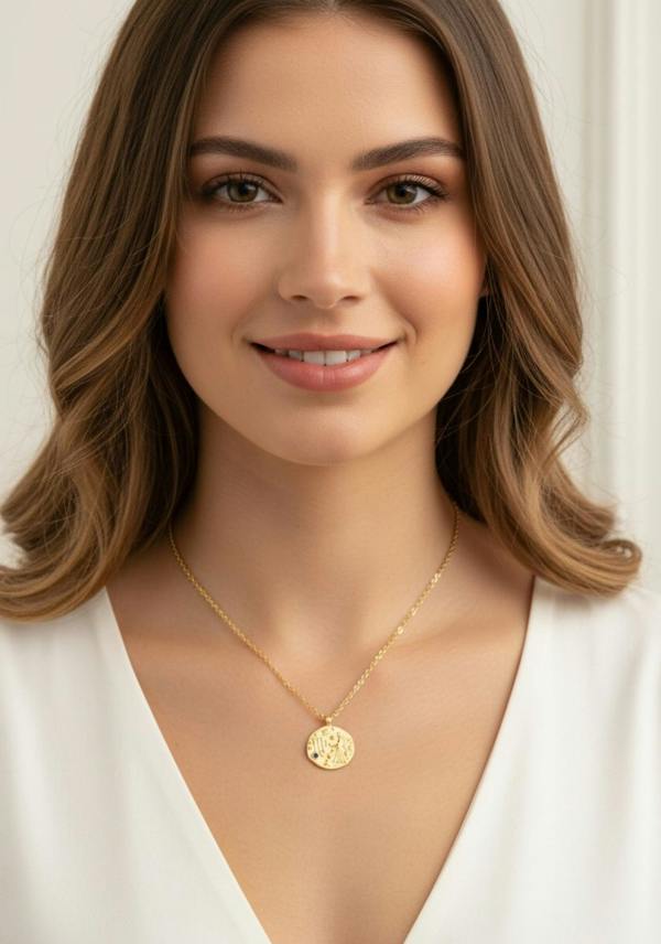 Woman wearing a gold necklace with a beige background