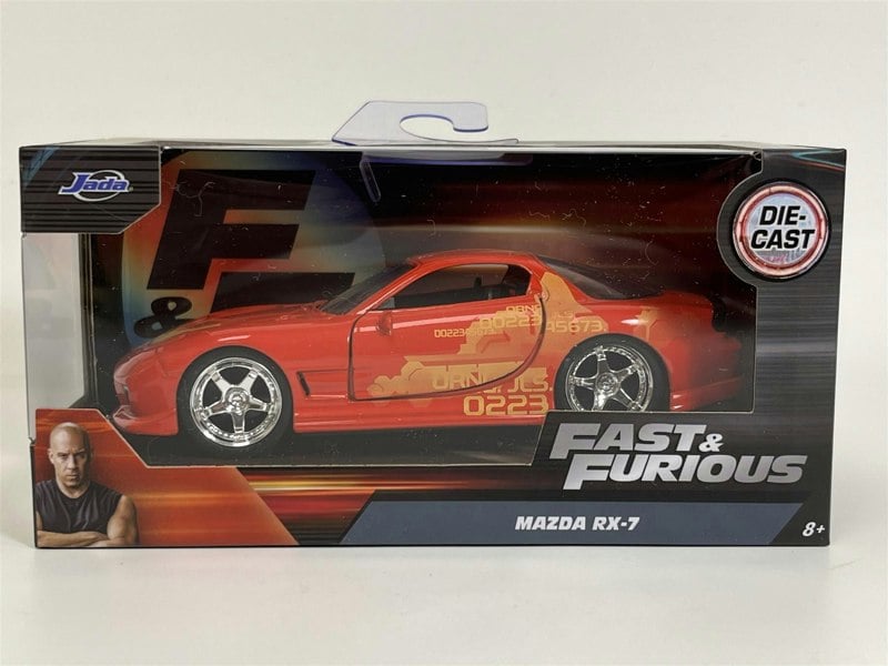 a red toy car in a box