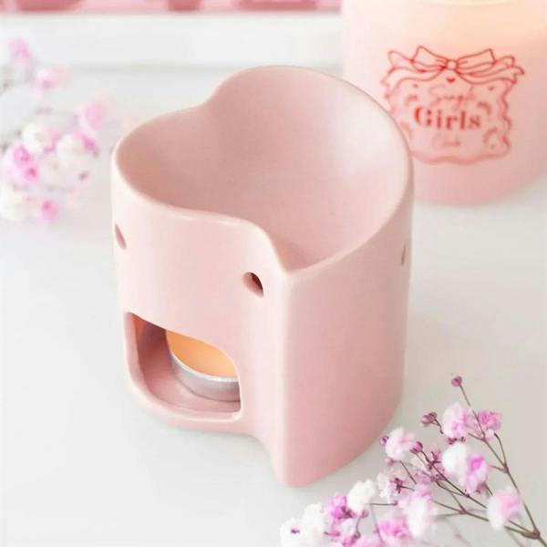 Pink heart-shaped oil burner with side opening and circular holes on the front